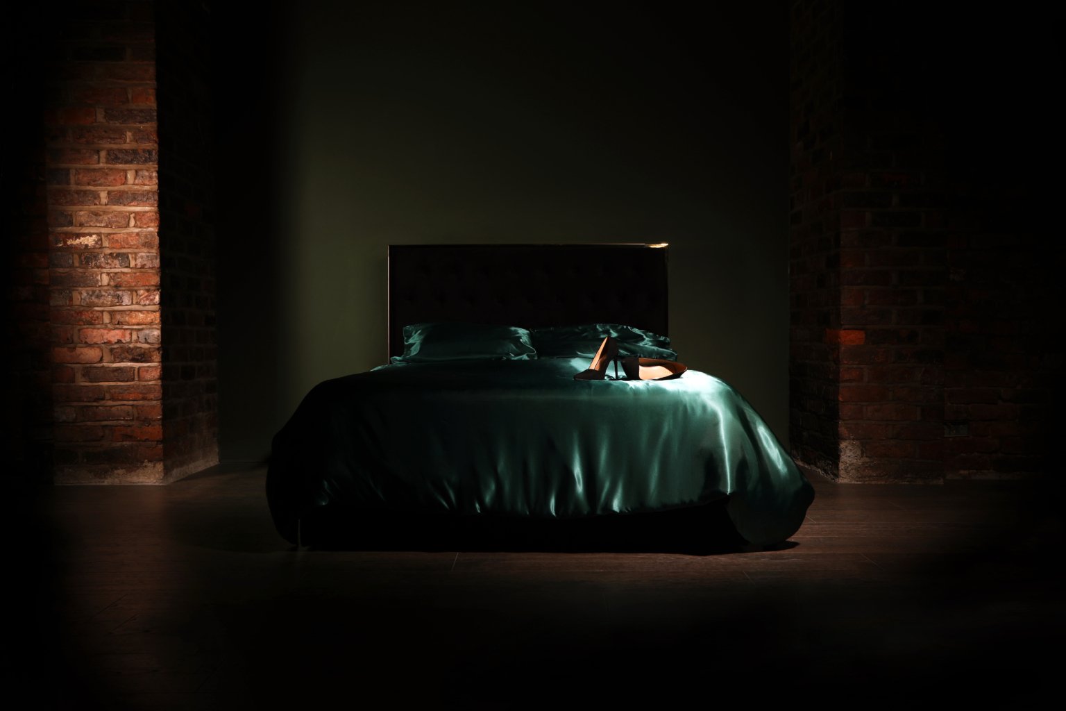boudoir photography studio in Manchester featuring a bed with green duvet cover